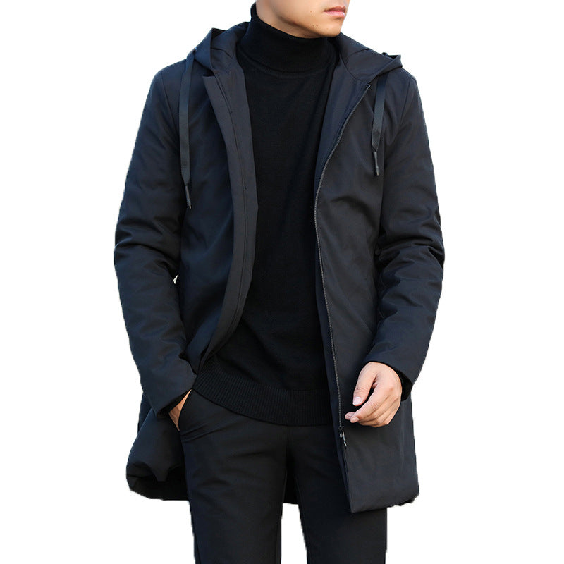 Person wearing a black jacket with a hood on a white background