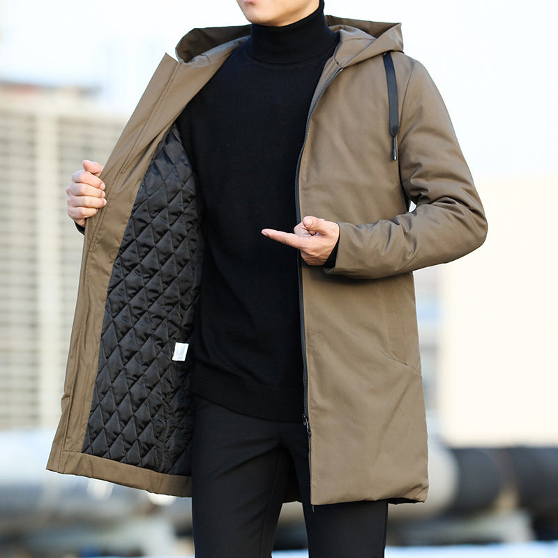 Person wearing a brown quilted jacket with a blurred background