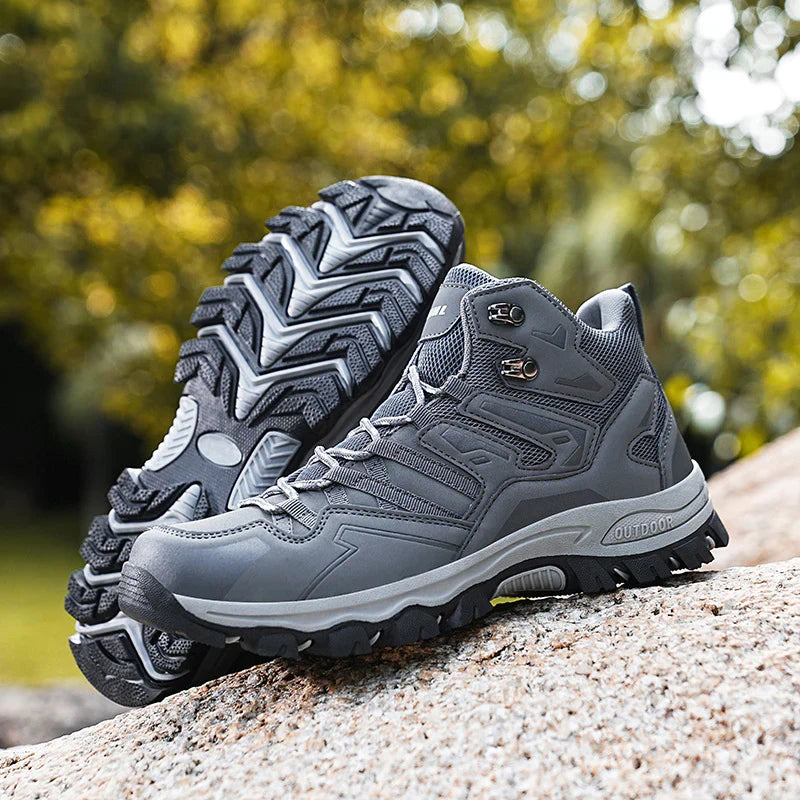 Gray hiking boots on a rock with a blurred natural background