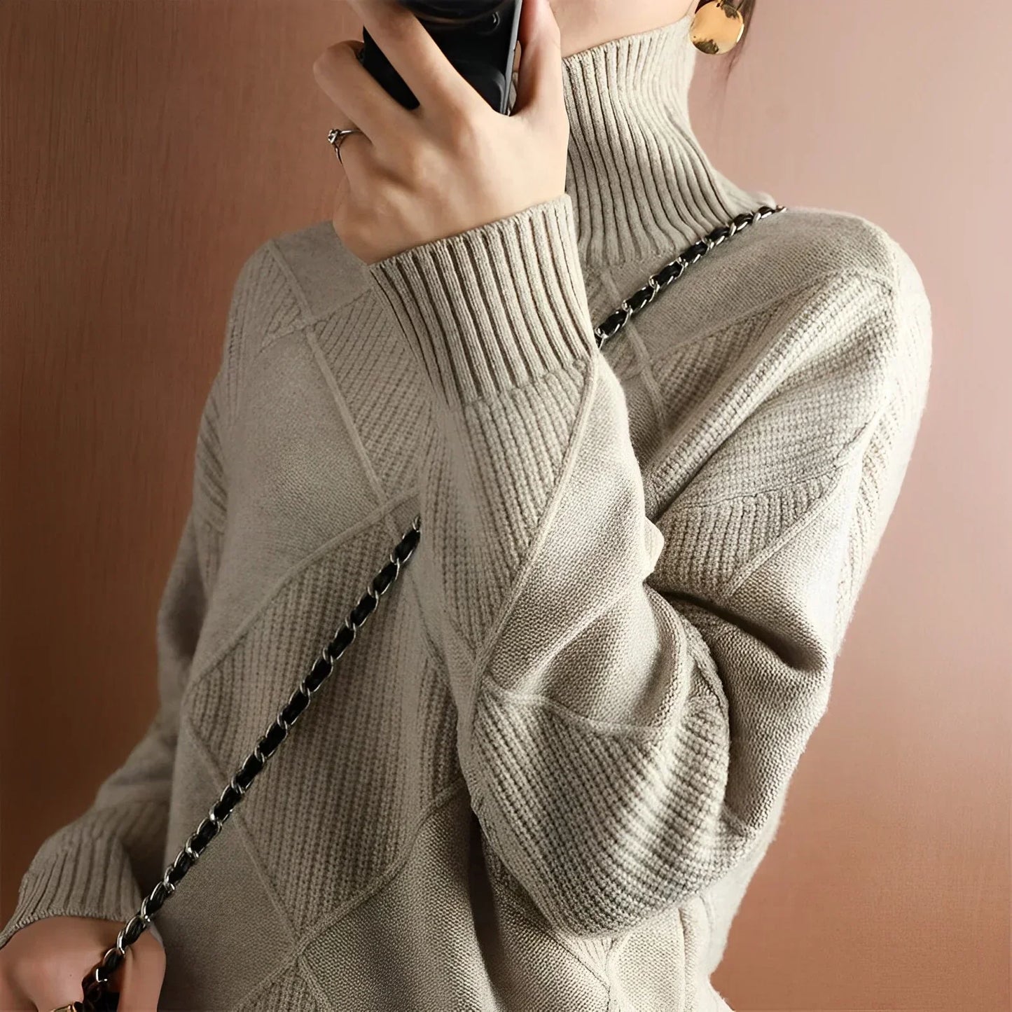 Person wearing a turtleneck sweater with dark pants