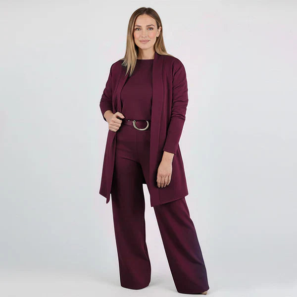 Woman wearing a burgundy suit on a white background
