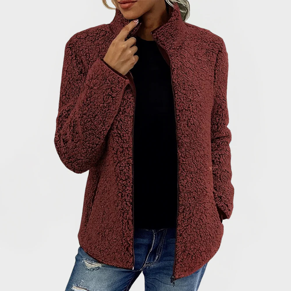 Person wearing a brown sherpa jacket on a white background