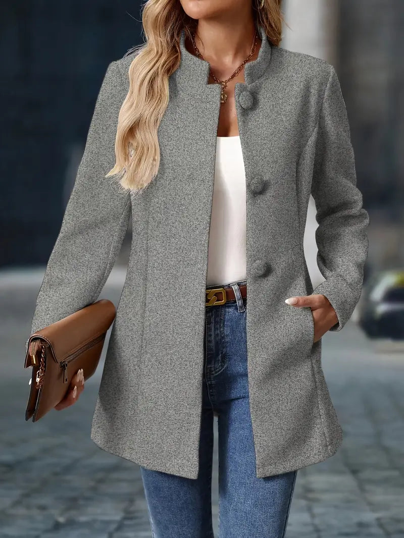 Woman wearing a gray coat with a blurred background