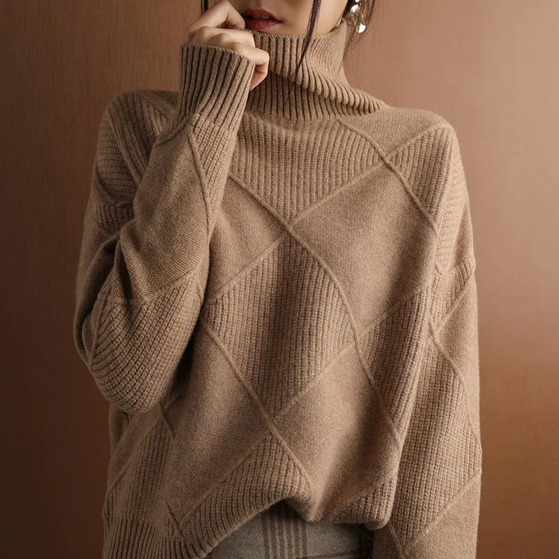 Person wearing a brown turtleneck sweater with dark pants