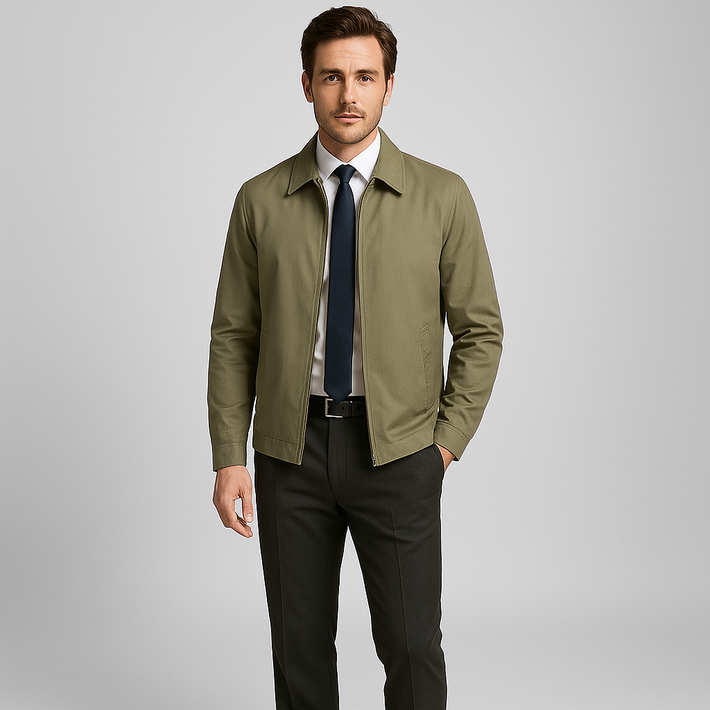 Man wearing a green jacket over a white shirt with a blue tie on a gray background