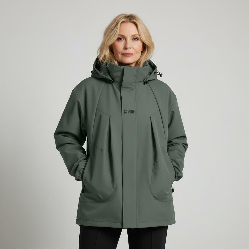 Woman wearing a green jacket on a plain background