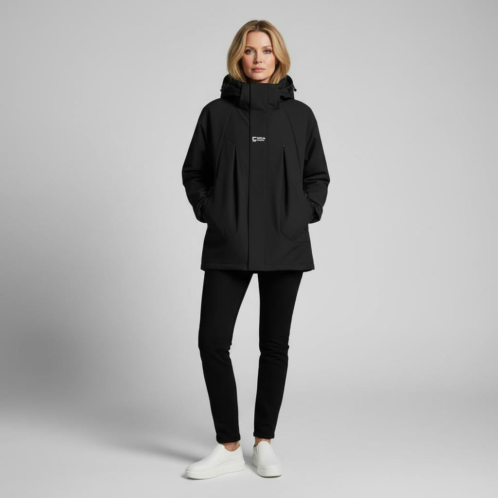 Person wearing a black jacket with a brand logo on a gray background