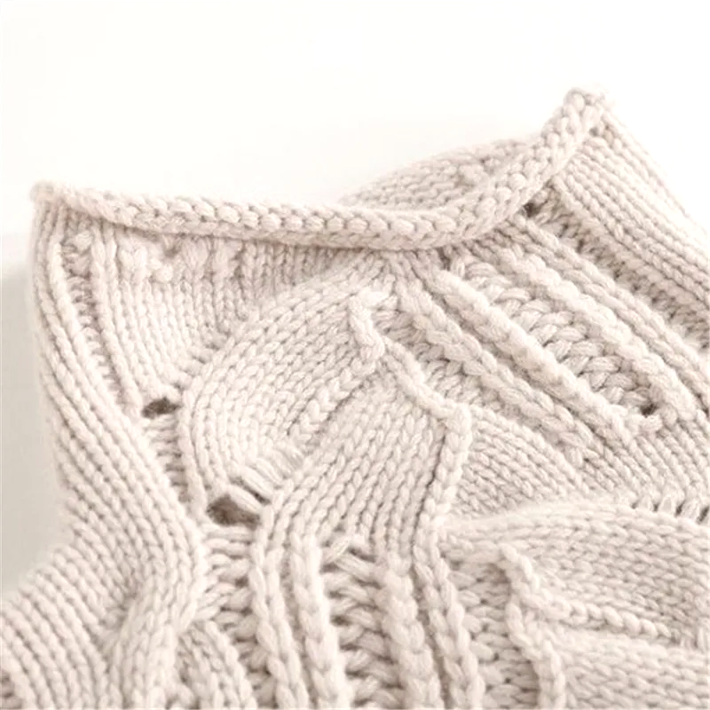 Close-up of a textured beige knitted fabric on a light background