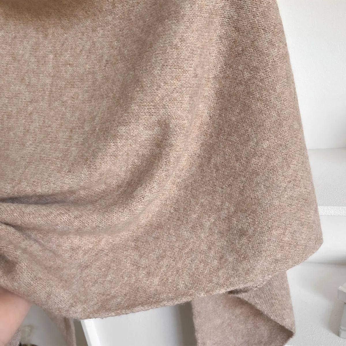 Close-up of a textured beige fabric on a white background