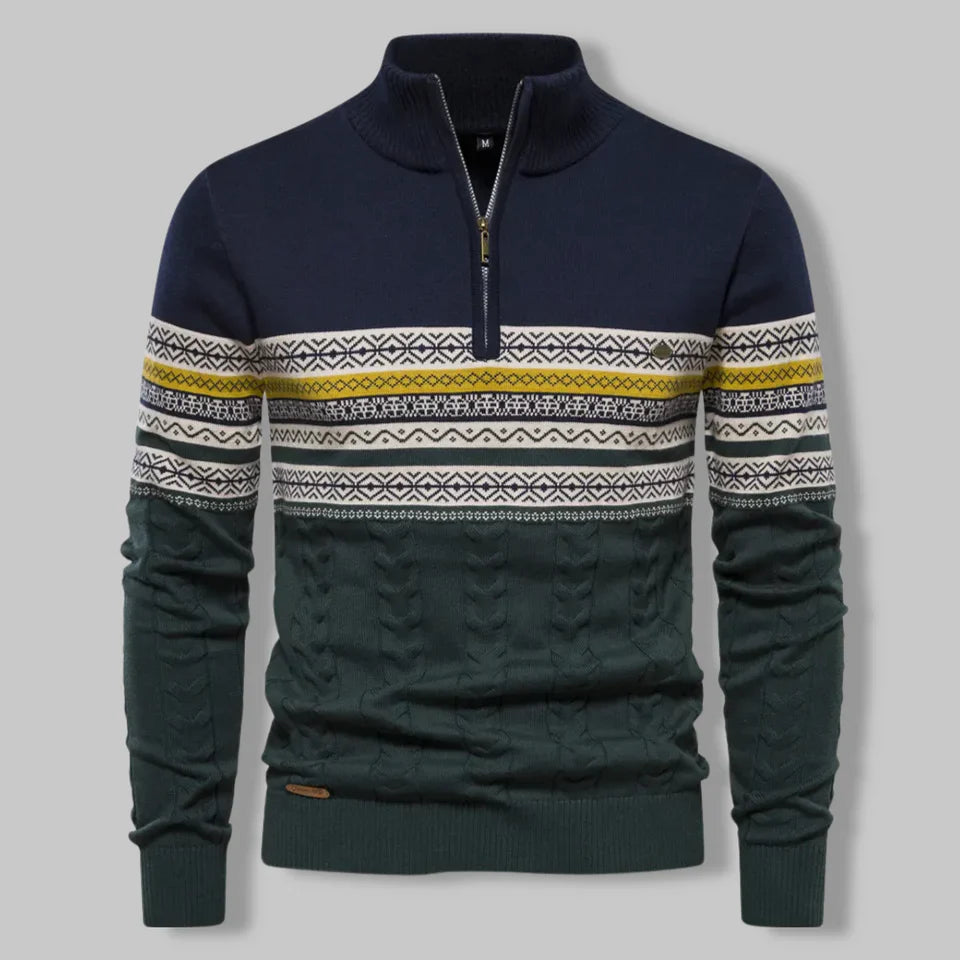 Navy sweater with patterned sleeves on a gray background