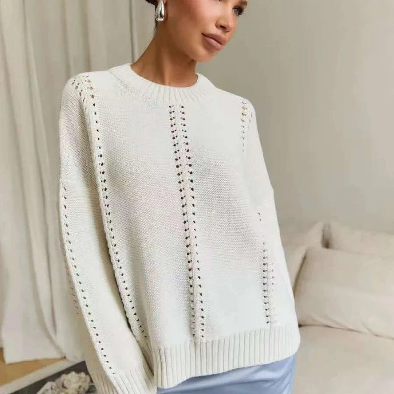 Woman wearing a white sweater with a neutral background