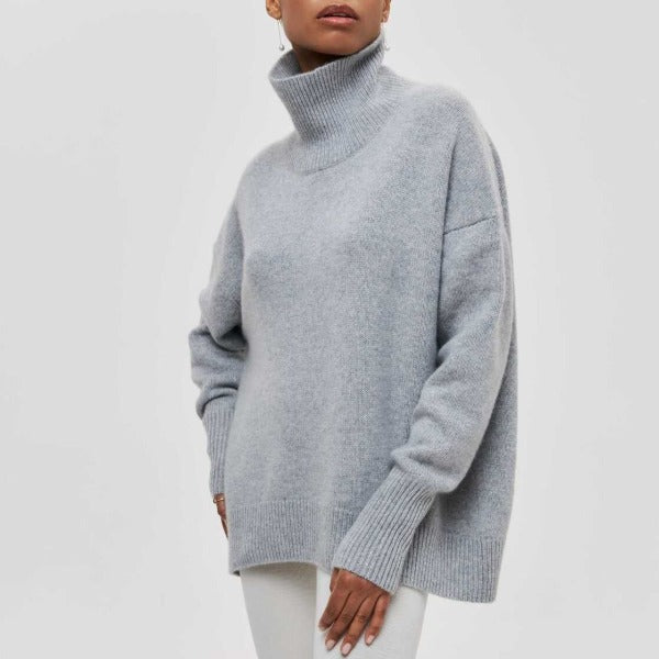 Person wearing a light gray sweater on a white background
