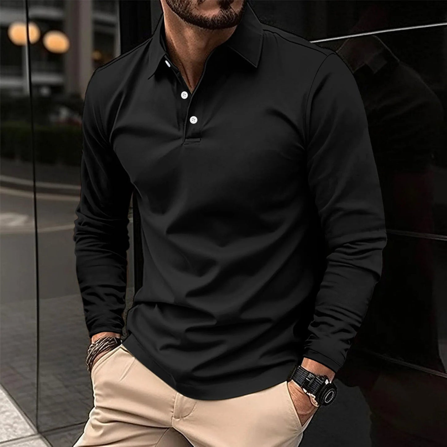 Man wearing a black long-sleeve polo shirt with beige pants.