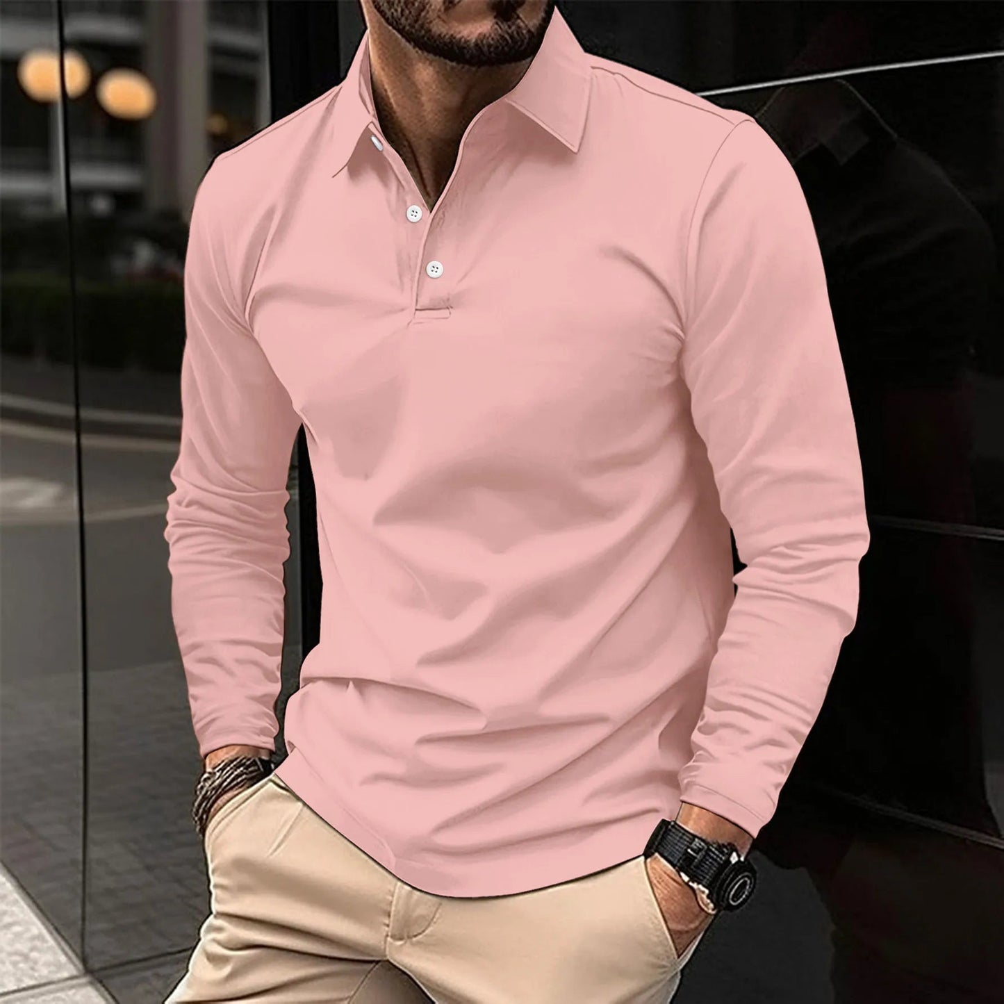 Man wearing a pink long-sleeve polo shirt with beige pants.