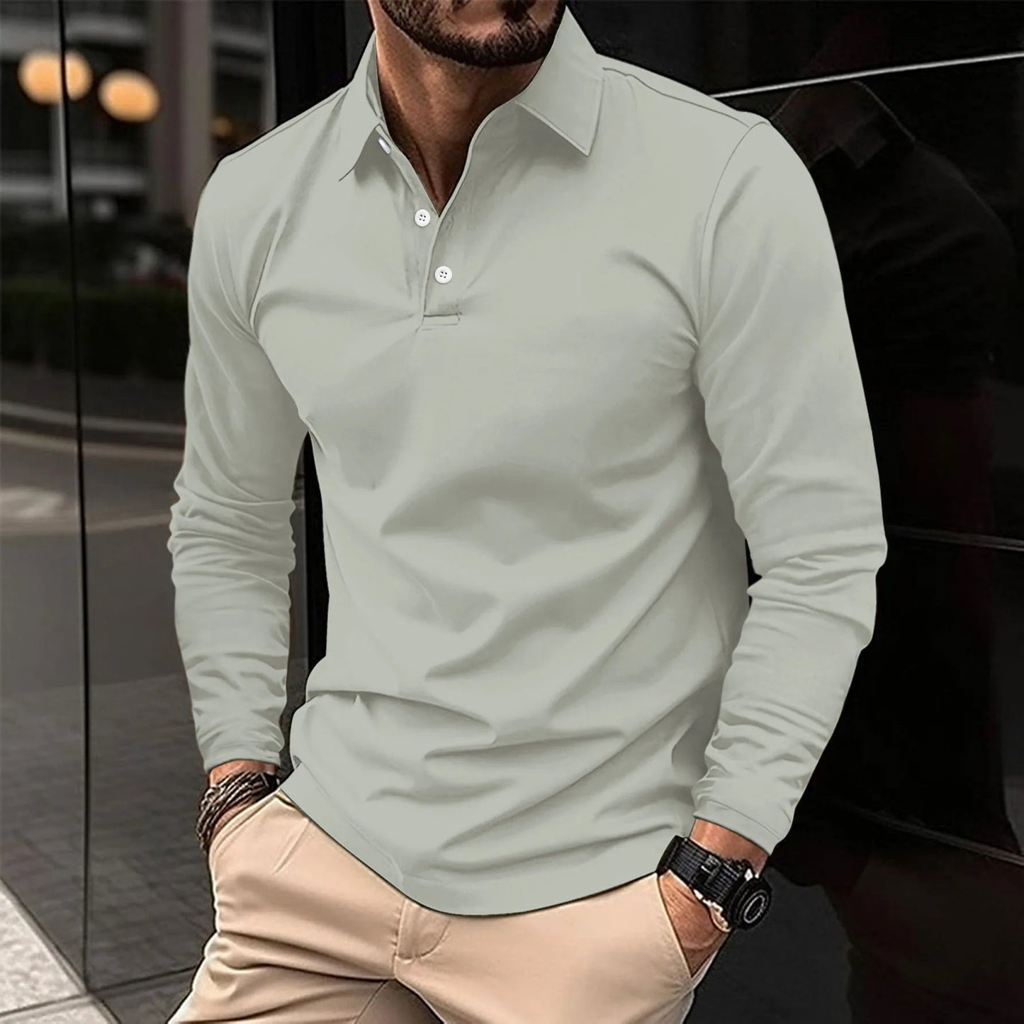 Man wearing a light gray long-sleeve polo shirt with beige pants.