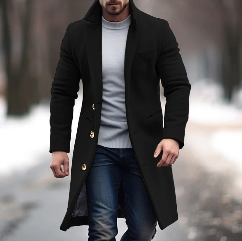 Man wearing a black coat with gold buttons in an outdoor setting