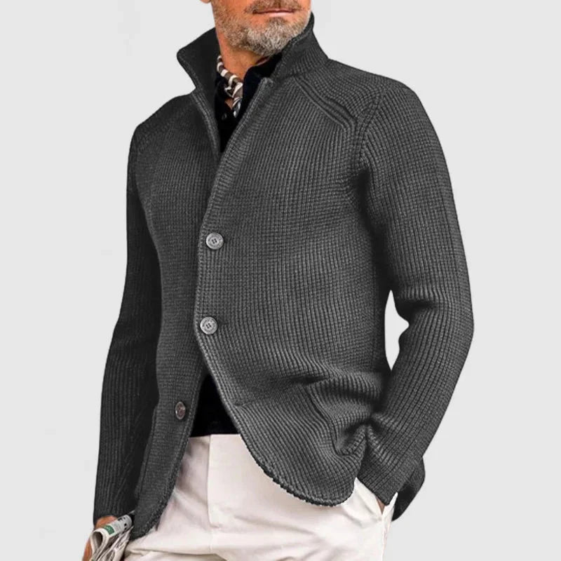 Man wearing a gray knitted cardigan on a light gray background