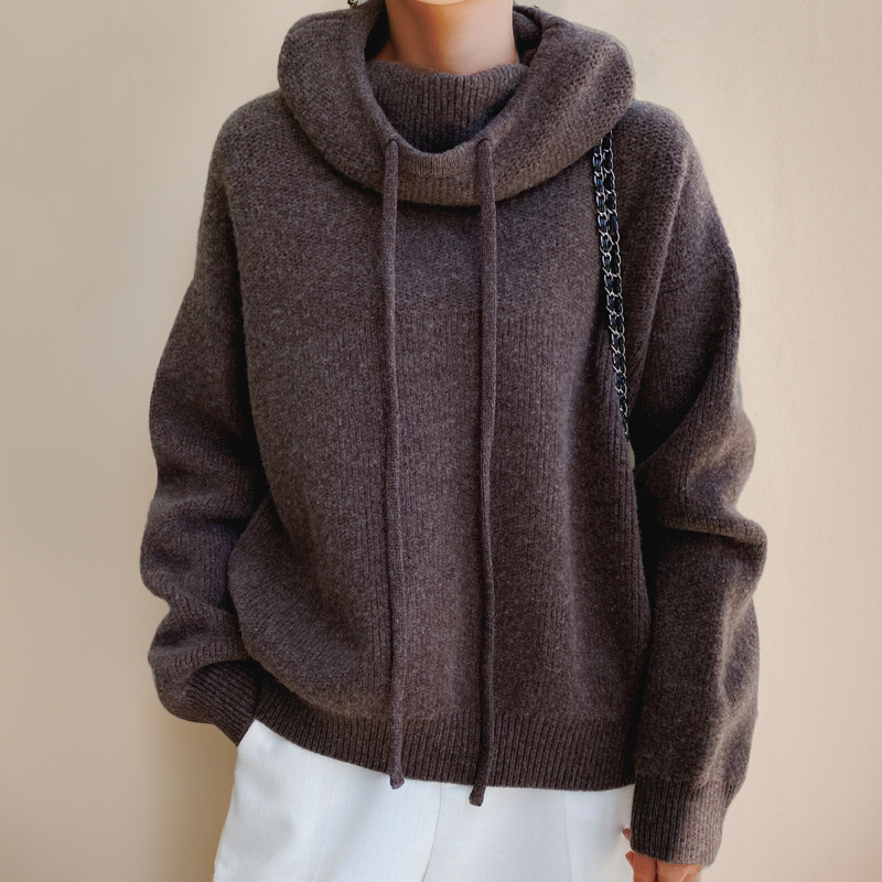 Person wearing a brown turtleneck sweater