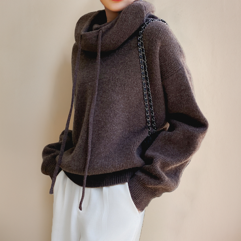 Person wearing a brown turtleneck sweater