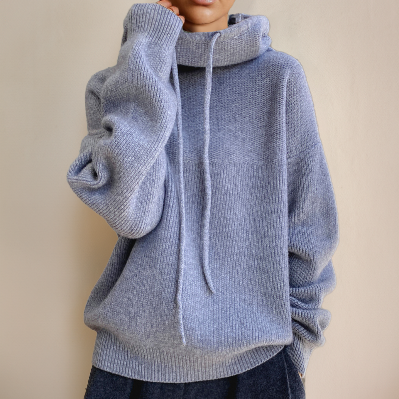 Person wearing a gray turtleneck sweater