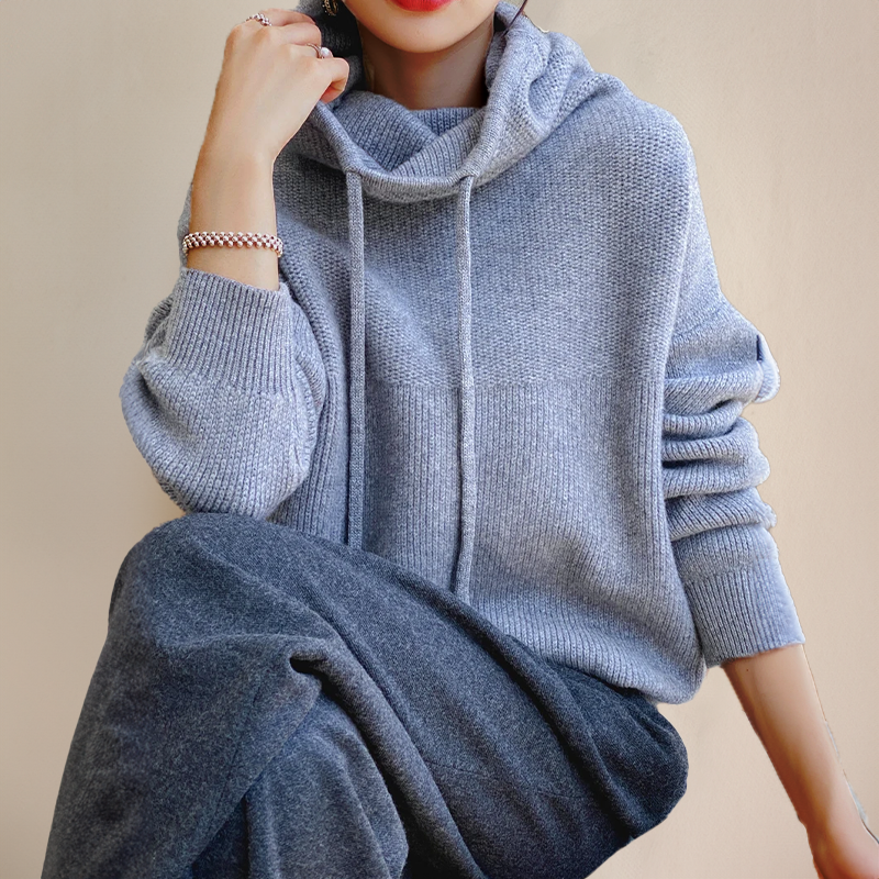 Person wearing a gray turtleneck sweater
