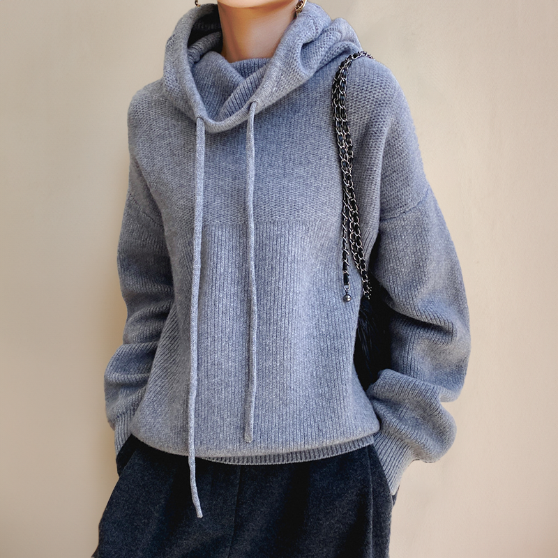 Person wearing a gray turtleneck sweater