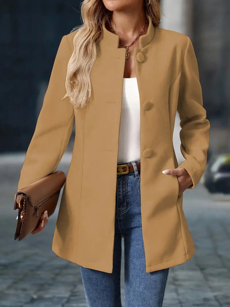 Person wearing a beige coat with a blurred background