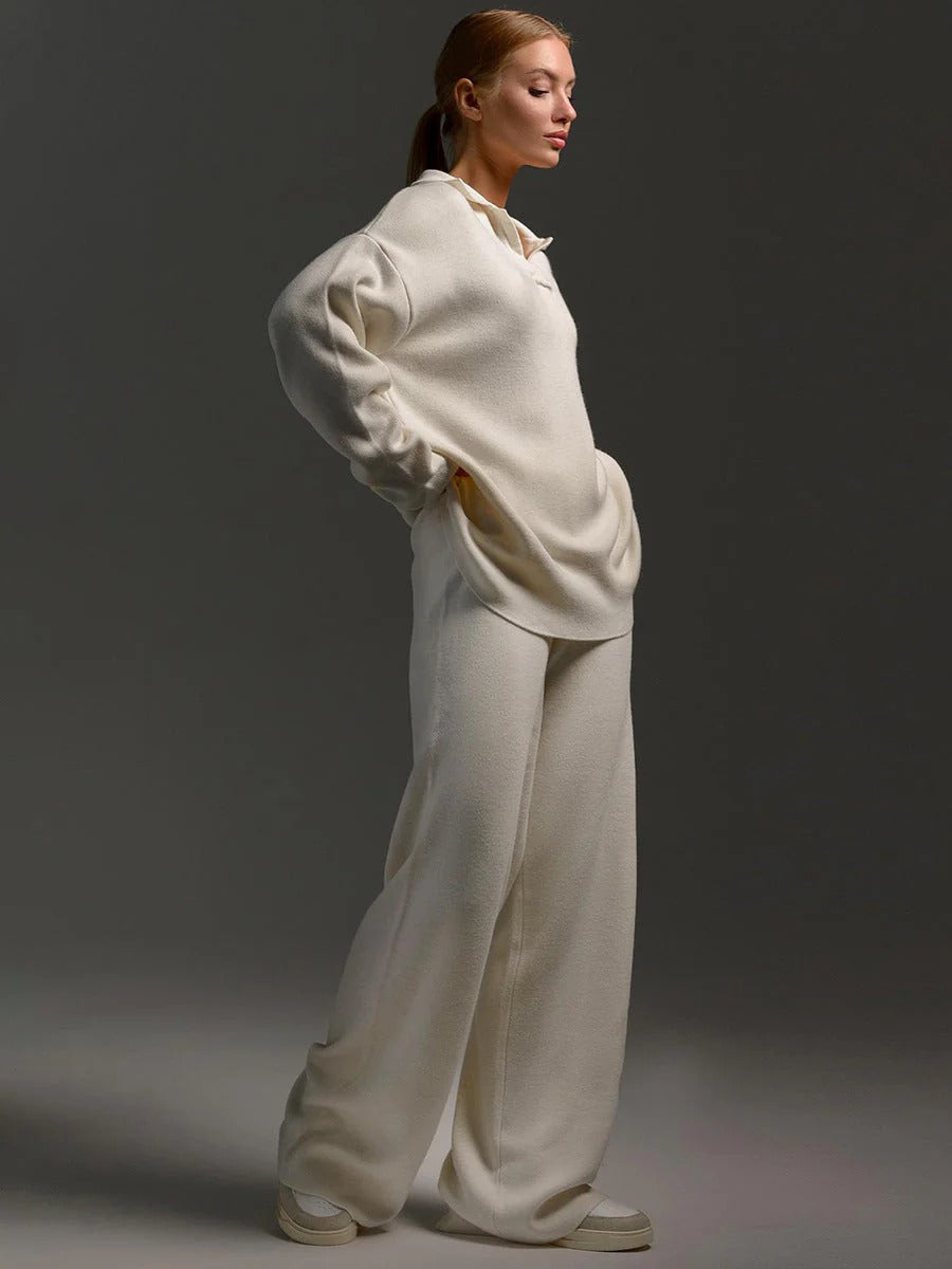 Person wearing a white outfit against a dark background