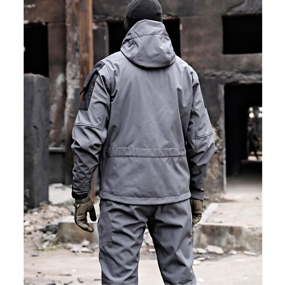Person wearing a gray tactical suit in an industrial setting