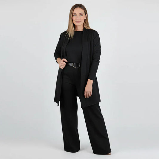 Woman wearing a black suit on a white background
