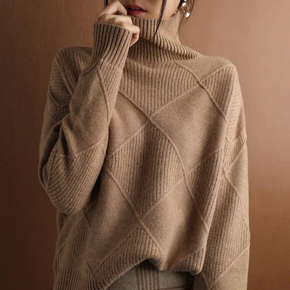 Person wearing a brown turtleneck sweater with dark pants