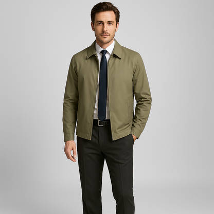 Man wearing a green jacket over a white shirt with a blue tie on a gray background