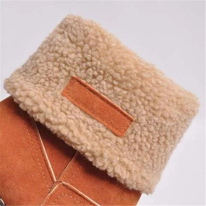 Close-up of a brown leather patch on a beige fleece material background