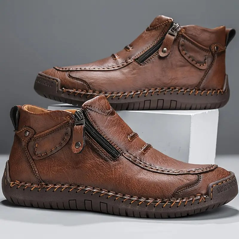 Brown leather shoes with zippers on a gray background