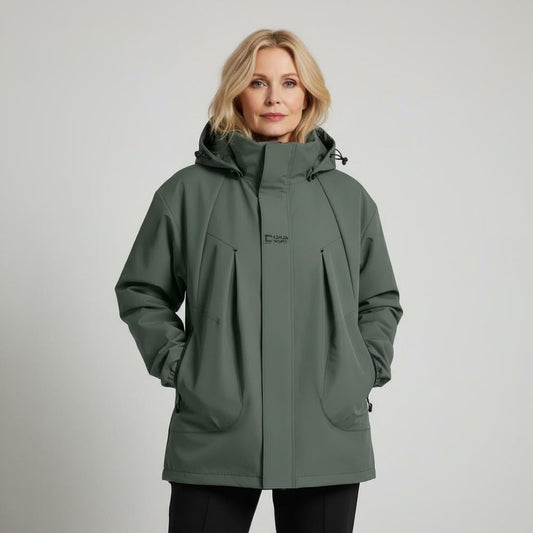 Woman wearing a green jacket on a plain background