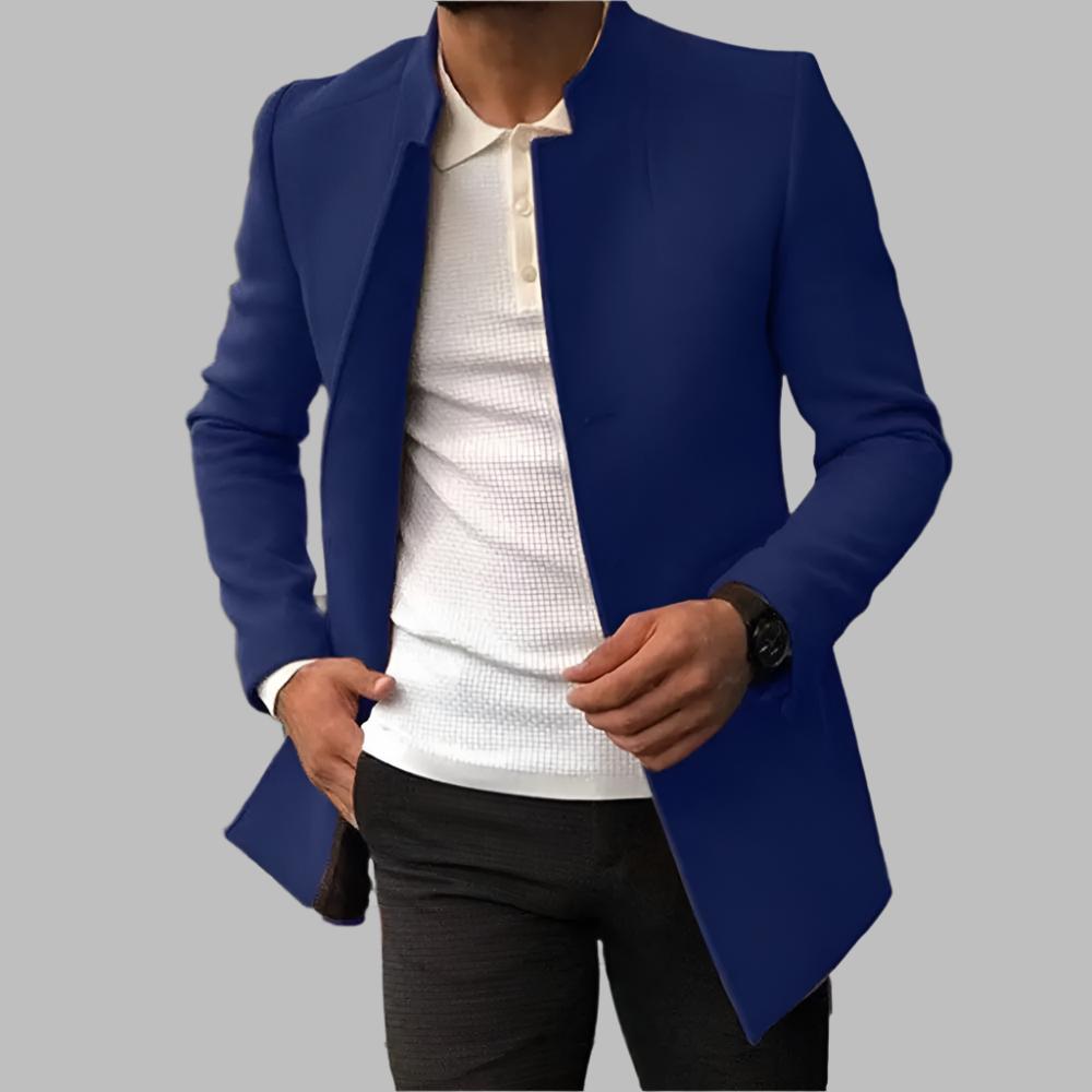Person wearing a blue blazer over a white shirt on a gray background