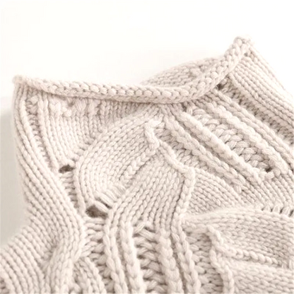 Close-up of a textured beige knitted fabric on a light background