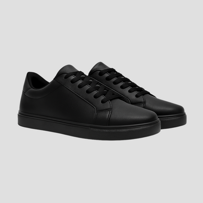 Pair of black sneakers on a light gray background