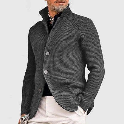 Man wearing a gray knitted cardigan on a light gray background