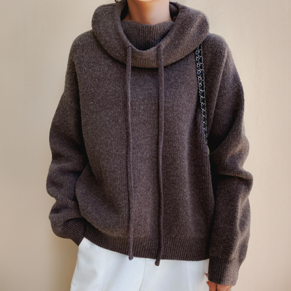 Person wearing a brown turtleneck sweater