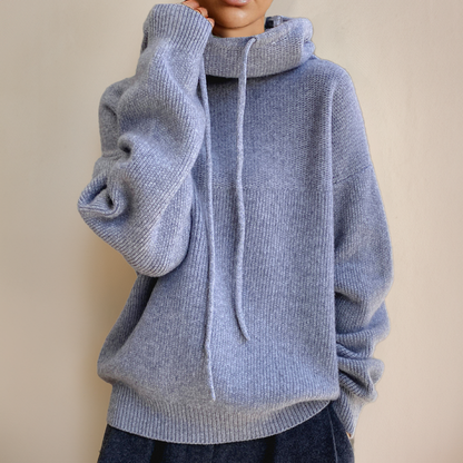 Person wearing a gray turtleneck sweater
