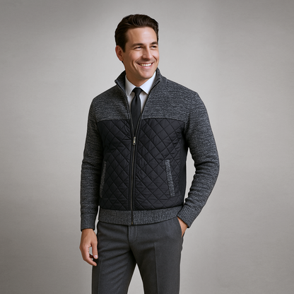 Man wearing a gray quilted jacket with a plain background